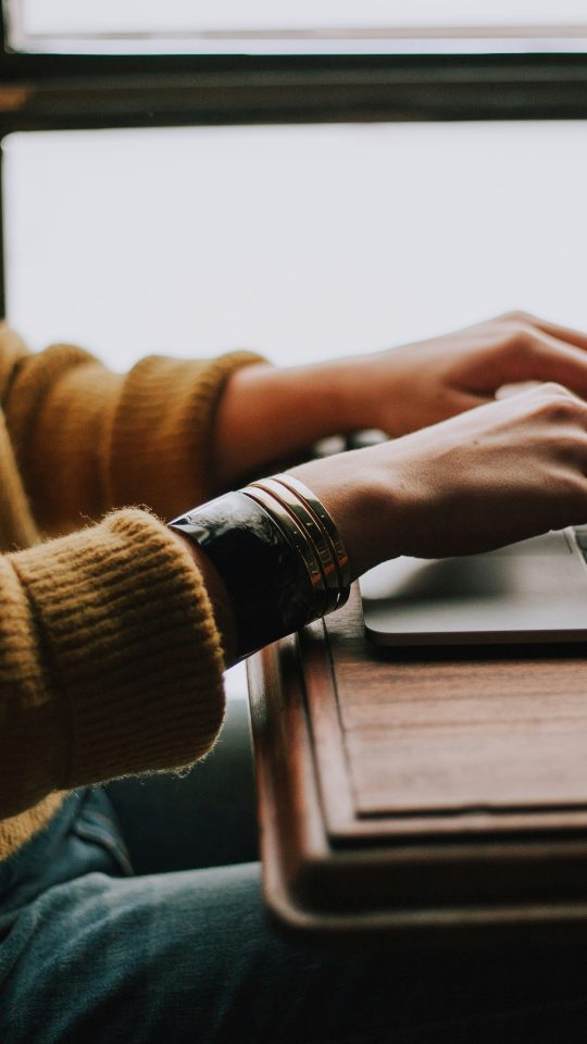 person sitting front of laptop